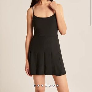 Black pleated traveler mini dress